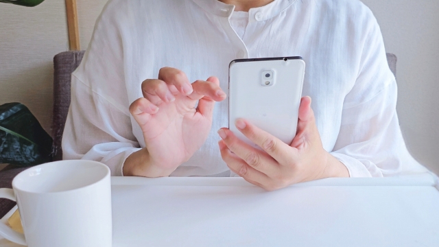 電話で問い合わせようとしている女性
